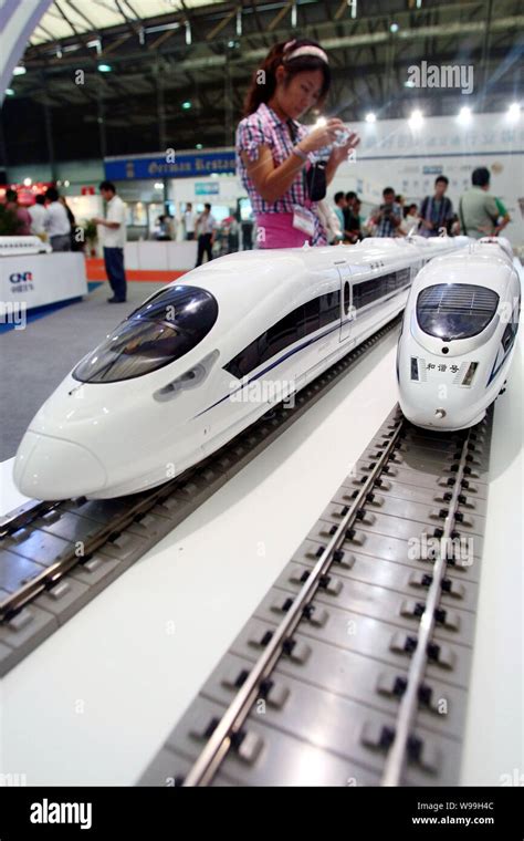 A Visitor Takes Photos Of Models Of CRH China Railway High Speed