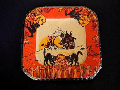 An Orange And White Square Plate With Halloween Images On It Sitting