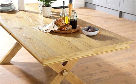 A Wooden Table With Wine Bottles And Bread On It