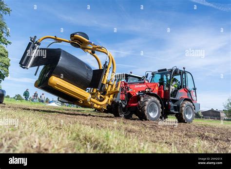 Wrapping Big Bales Of Silage With An Attachment On The Front Of A