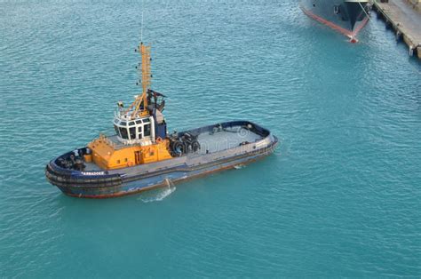 Tug Boat In Caribbean Harbour Port Blue Water Top View Stock Photo