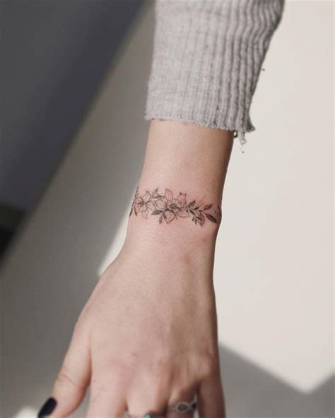 Cute Feminine Flower Armband Tattoo On Wrist Tattoo Designs For Women