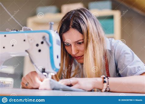 Seamstress Dressmaker Woman Working With Sewing Machine In Workshop