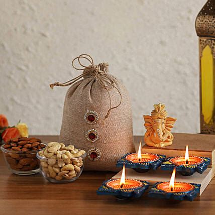 Buy Send Beige Ganesha Idol With Diyas Dried Nuts Potli Online Fnp