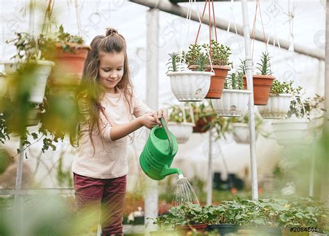 Mother And Daughter Taking Care Of Plants, Stock Photo | Crushpixel