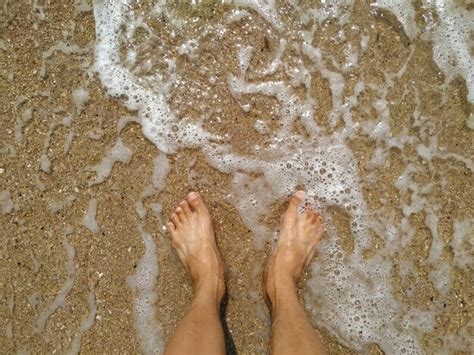 Premium Photo Low Section Of Person Standing At Beach