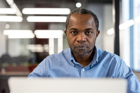 Mature African American Office Worker Focused At Workplace Inside Modern Office Stock Photo