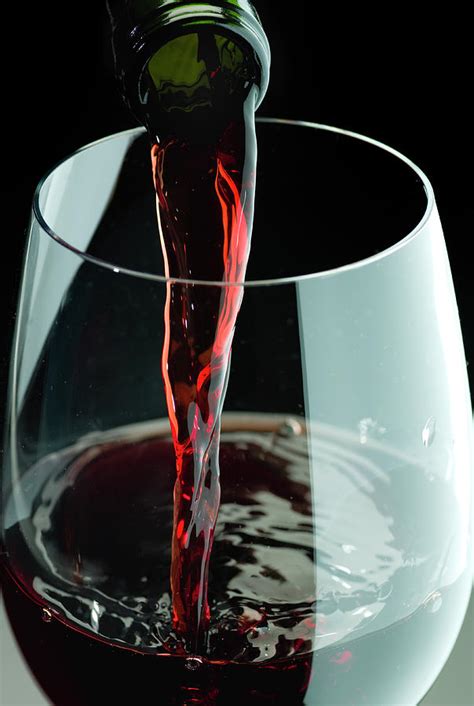 Wine Bottle Pouring Into Glass