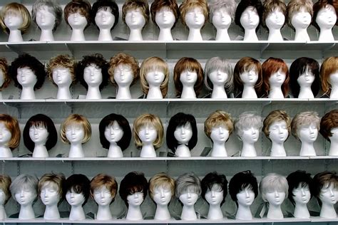 Wigs For Sale On Shelf Display By Stocksy Contributor Raymond Forbes