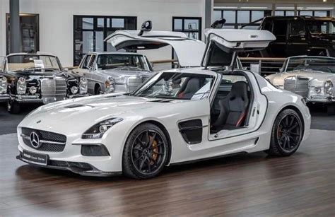 the mercedes sls amg roadster is parked in front of several other cars