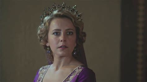 A Woman In A Purple Dress Wearing A Tiara