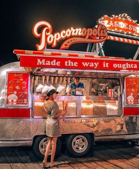 A Woman Standing In Front Of A Food Truck