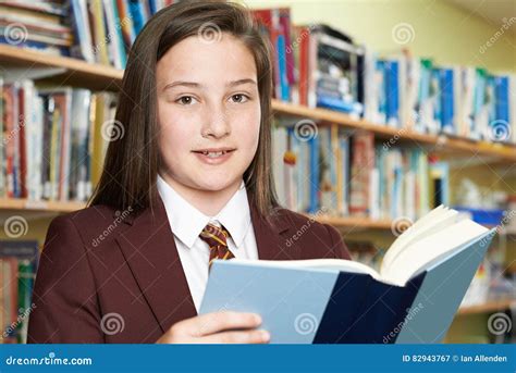 Girl Wearing School Uniform Reading Book in Library Stock Image - Image ...