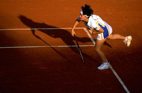 Martina Hingis Of Switzerland Serves by Clive Brunskill