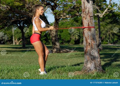 Athletic Woman Workout With Resistance Band Outdoors Fitness Girl