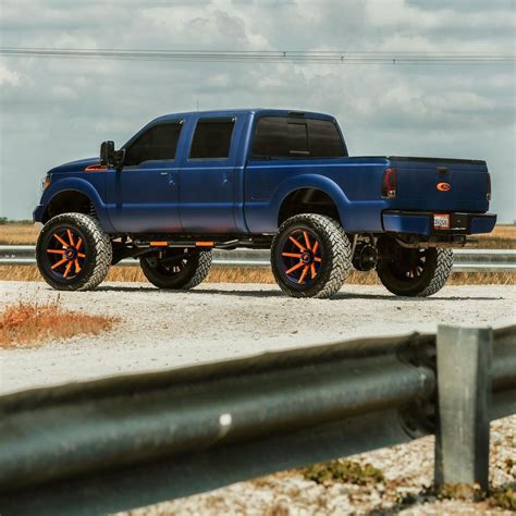 Lifted Blue And Orange Wrapped Ford F 250 Super Duty Rides On Matching Forgiatos Autoevolution