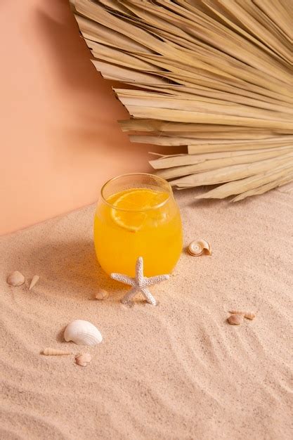 Free Photo Summertime Vibes With Sand And Orange Cocktail