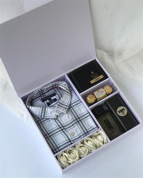 An Open Box Containing Several Items Including A Shirt Tie And Other