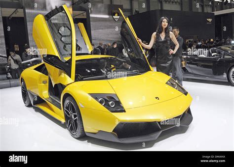 A Model Poses Next To A Lamborghini Murcielago Lp Superveloce On