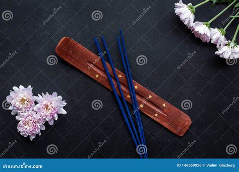 Air Freshener Sticks With Flowers On Dark Background Top View Stock