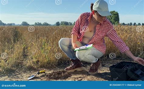 Female Agronomy Scientist Preparing For Soil Measurements Outdoors