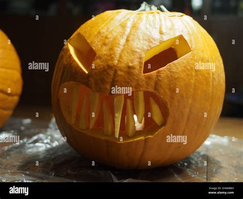 Carved jack-o-lantern with an evil face Stock Photo - Alamy