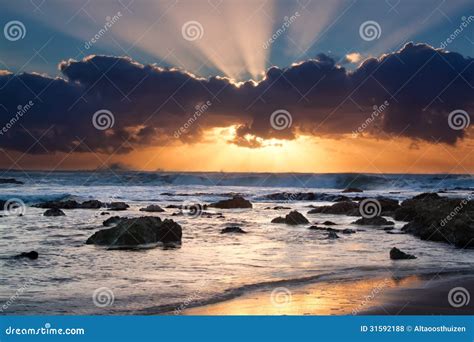 Sunrise Landscape Of Ocean With Waves Clouds And Rocks Stock Photo