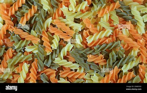 Top View Of The Pile Of Spiral Shaped Three Color Fusilli Pasta For