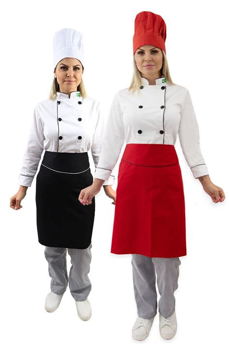 Two Women In Chef S Uniforms Standing Next To Each Other With Their