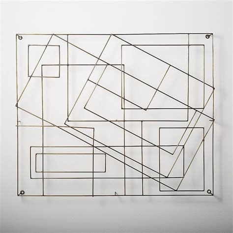 a metal sculpture on a white wall with lines and rectangles in the center