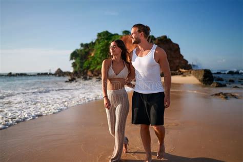 Couple Strolls Beachside Romantic Walk By Sea Man Woman In Casual